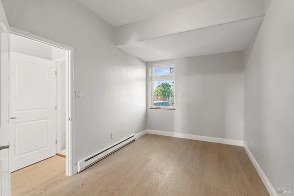 a view of an entryway with wooden floor