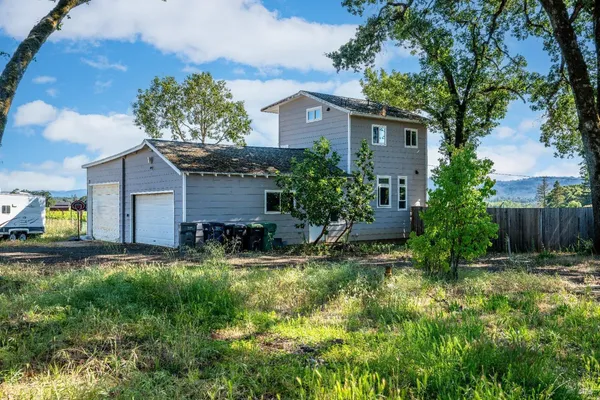 a view of a house with a yard and plants