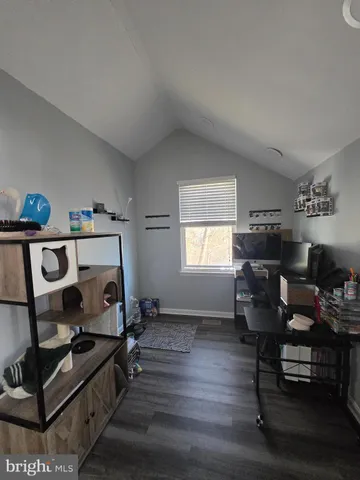 a view of a workspace with furniture and a window