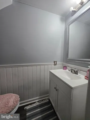 a bathroom with a sink a toilet and vanity