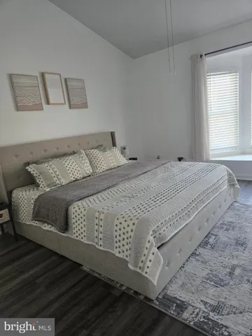 a bedroom with a bed and window