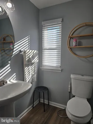 a white toilet sitting next to a window