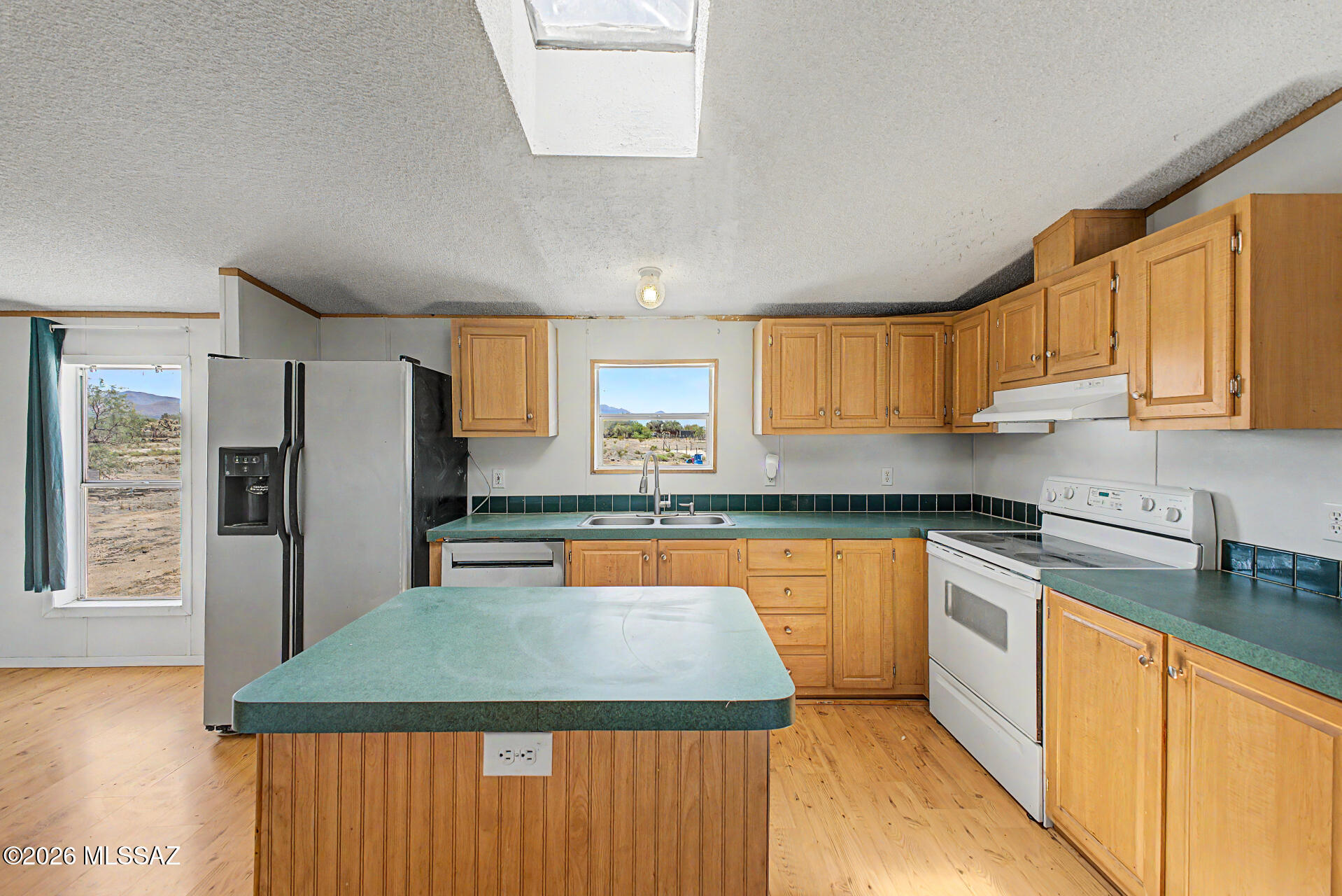 1911 West Thunder Road Vail, AZ 85641 - Photo 11 of 38 a kitchen with stainless steel appliances granite countertop a sink stove refrigerator and cabinets