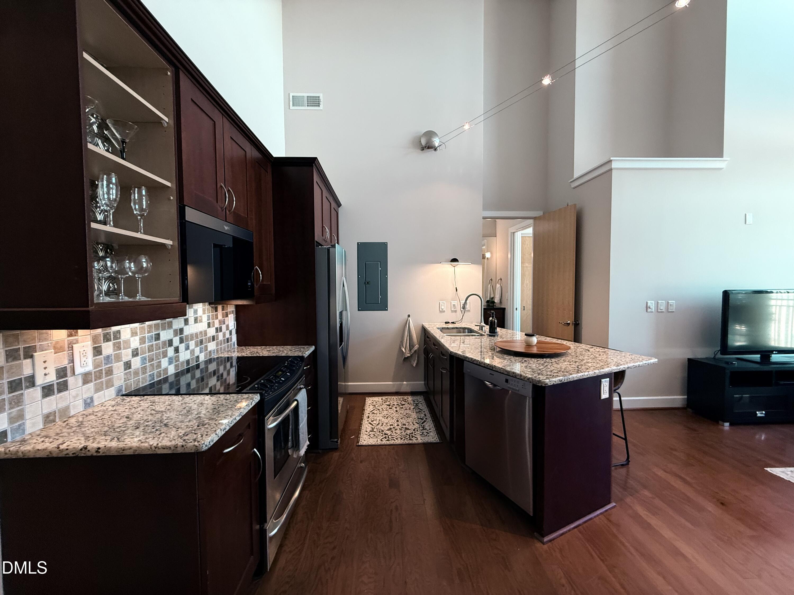2608 Erwin Road, Unit 421 Durham, NC 27705 - Photo 14 of 45 a kitchen with stainless steel appliances granite countertop a stove and a refrigerator