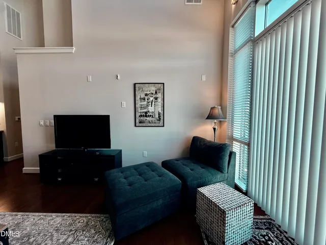 a living room with a kitchen island furniture and a table