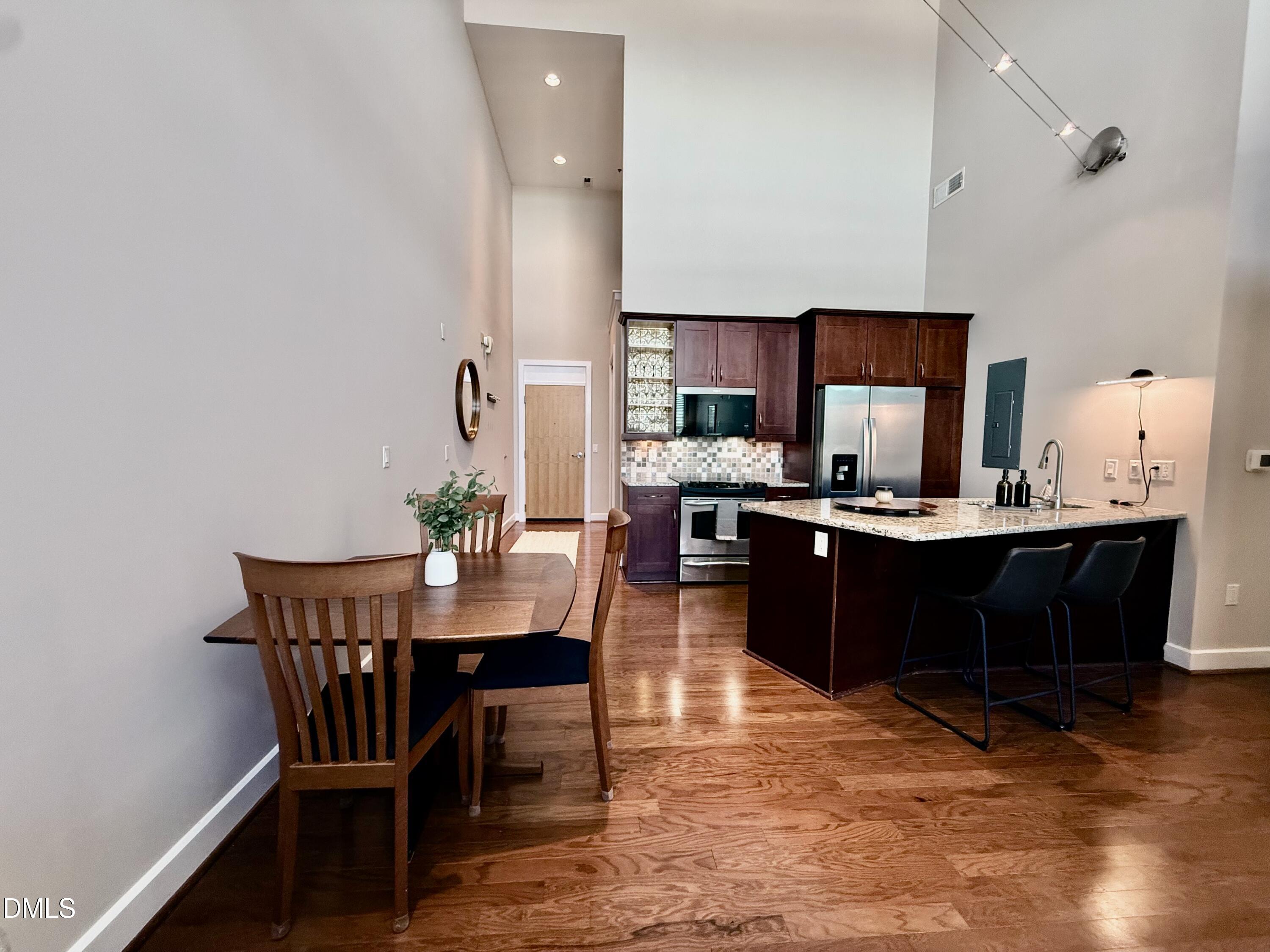 2608 Erwin Road, Unit 421 Durham, NC 27705 - Photo 21 of 45 a living room with a kitchen island furniture and a table