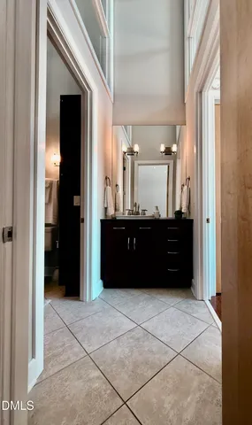 a bathroom with a double vanity sink and a mirror