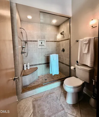 a bathroom with a toilet sink and shower
