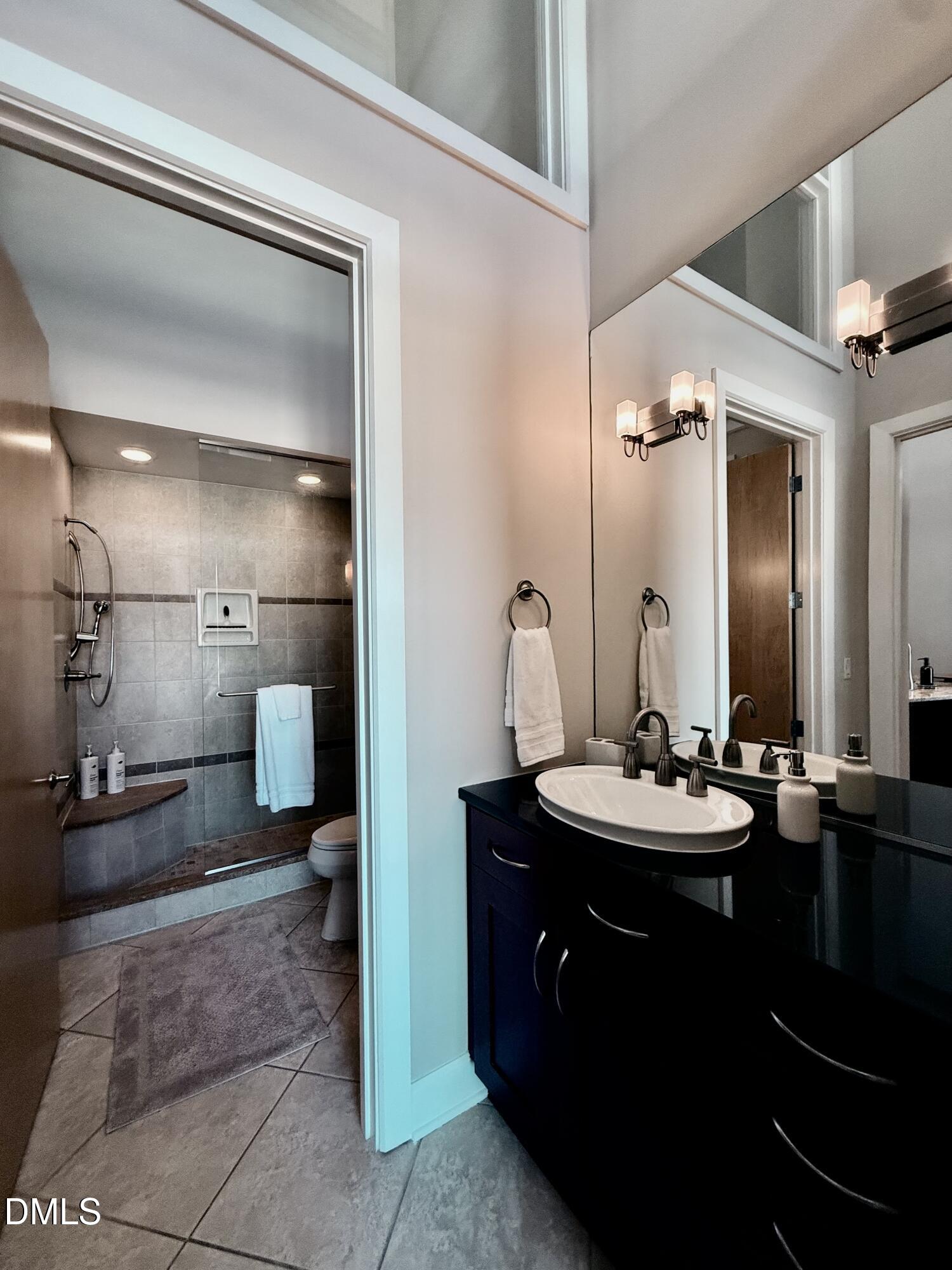 2608 Erwin Road, Unit 421 Durham, NC 27705 - Photo 30 of 45 a bathroom with a double vanity sink and a mirror