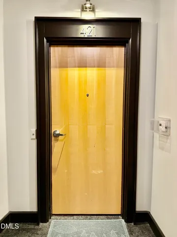 a kitchen with wooden floor and refrigerator