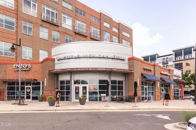 a view of a cars park in front of a building