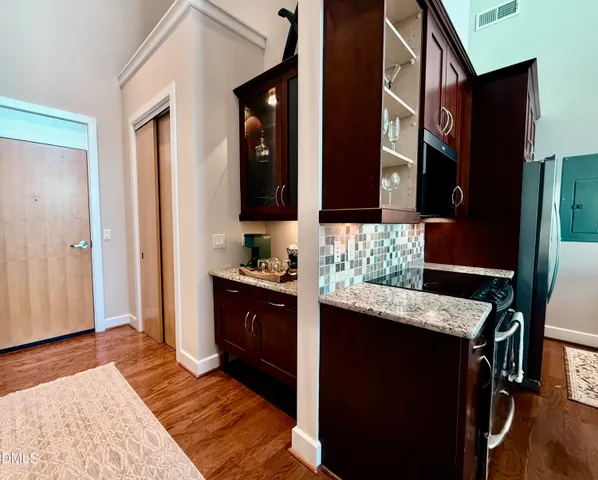 a kitchen with kitchen island granite countertop wooden cabinets and stainless steel appliances