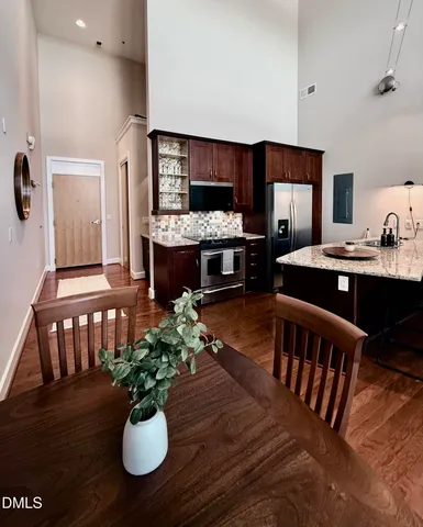 a dining room with furniture and wooden floor