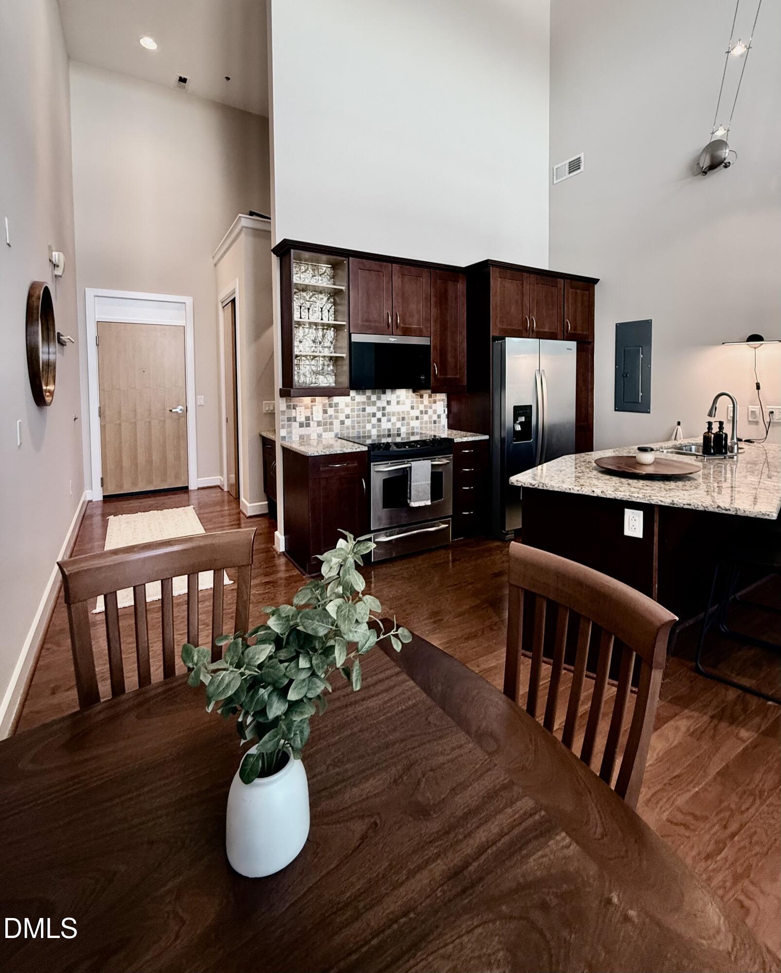 2608 Erwin Road, Unit 421 Durham, NC 27705 - Photo 8 of 45 a dining room with furniture a rug and wooden floor