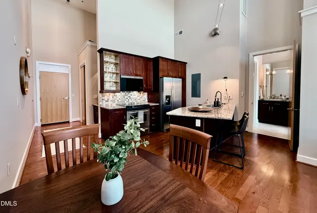 a kitchen with granite countertop a sink and a refrigerator