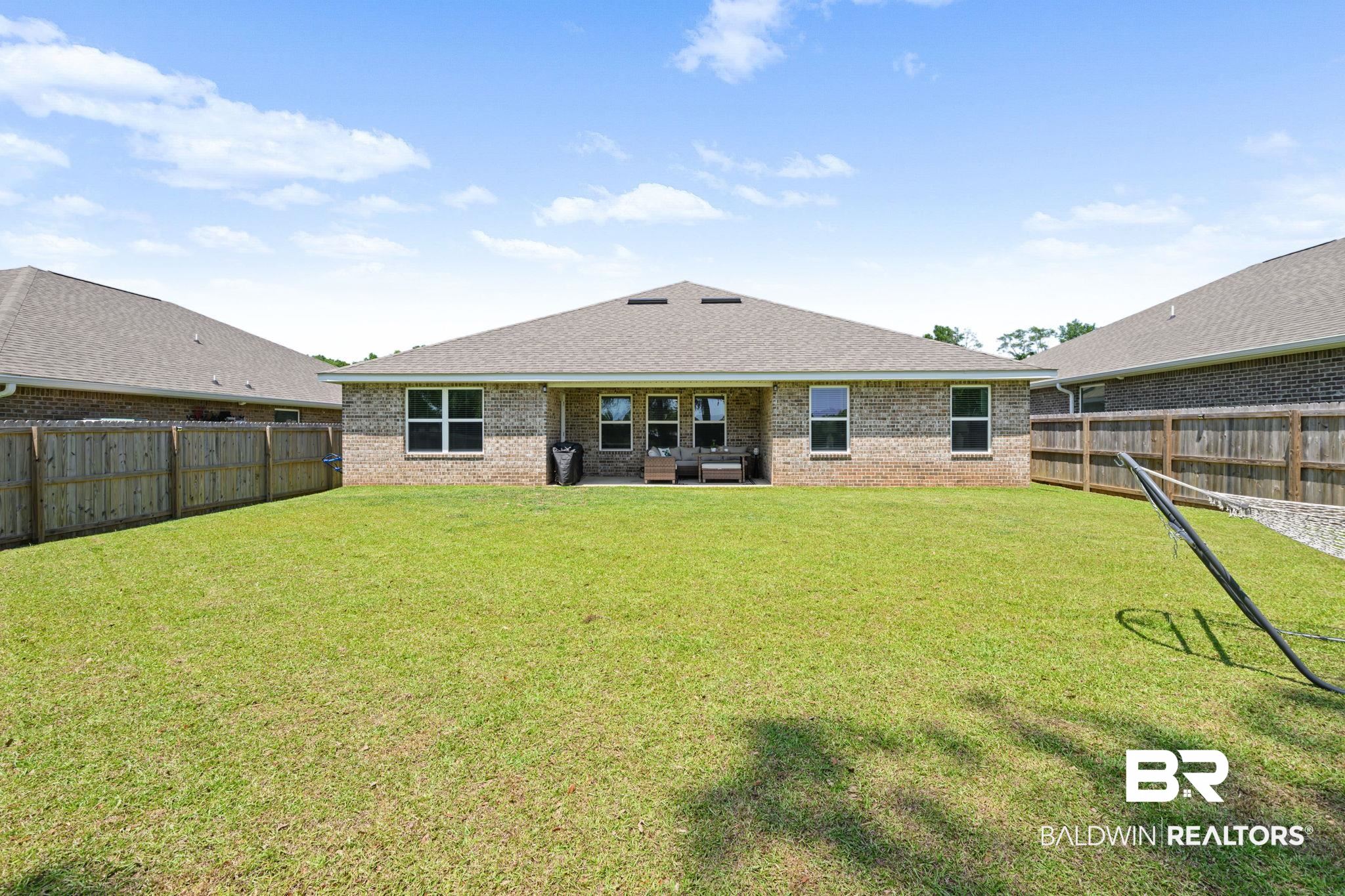 8021 Valor Rdg Way North Mobile, AL 36619 - Photo 6 of 34 Expansive green lawn with a full privacy fence