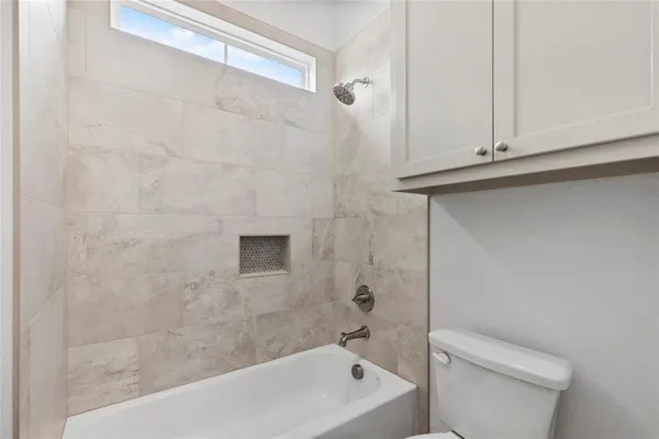 a bathroom with a granite countertop sink and a toilet