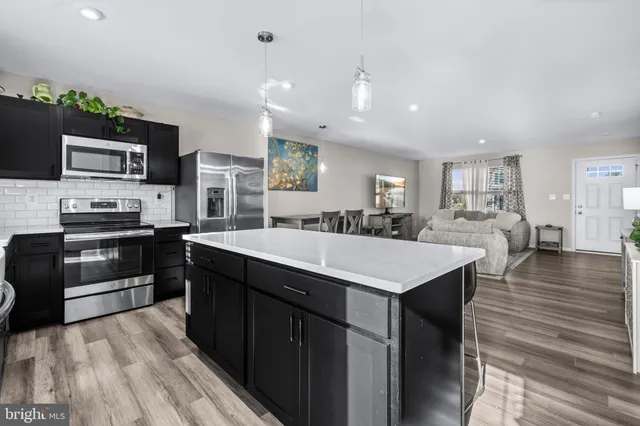 a kitchen with a sink stove and microwave
