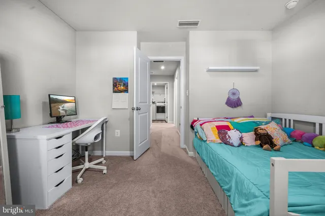 a bedroom with a bed and wall painting