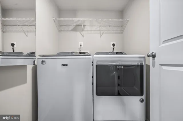a bathroom with a granite countertop bathtub sink vanity and toilet