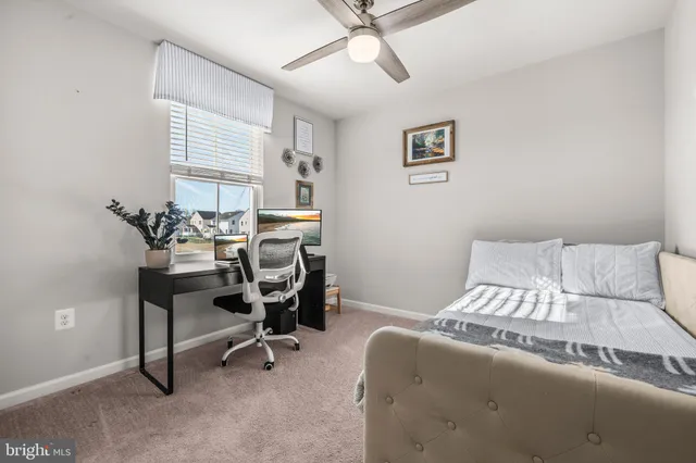 a living room with hard wood floors and a ceiling fan