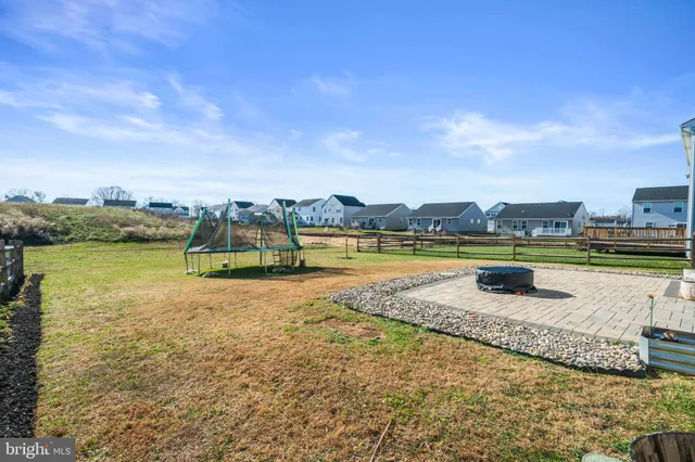 an aerial view of a house with a garden and lake view