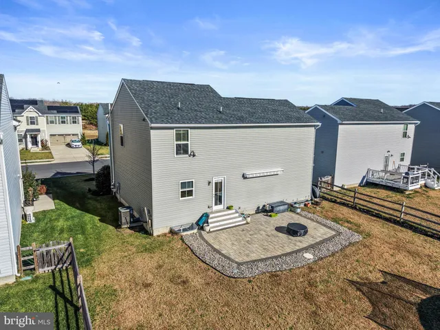 an aerial view of a house with a garden and lake view