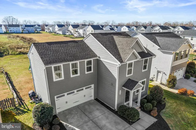 an aerial view of a house with swimming pool outdoor seating