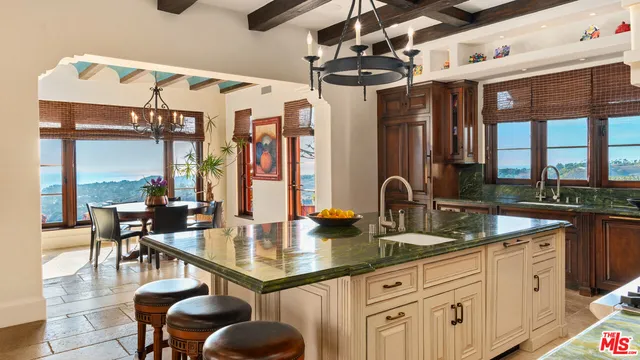 a kitchen with stainless steel appliances granite countertop a sink and wooden cabinets