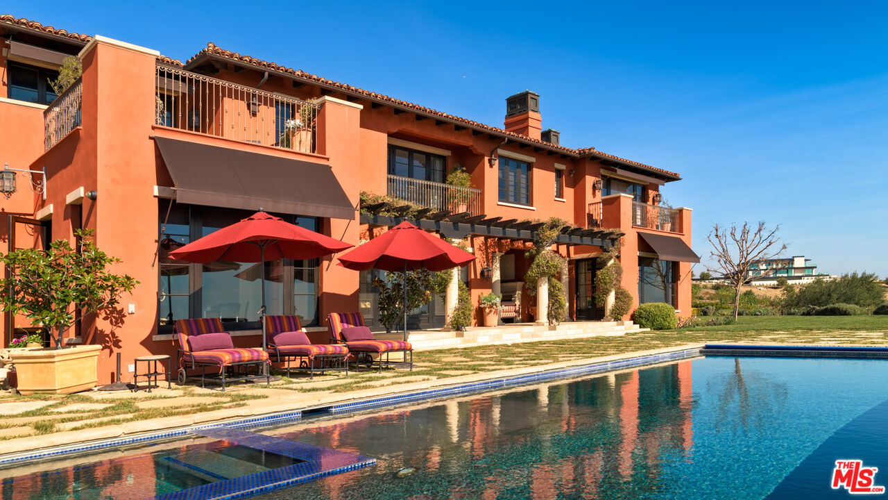 6093 Murphy Way Malibu, CA 90265 - Photo 26 of 52 a view of a building with a swimming pool and sitting area