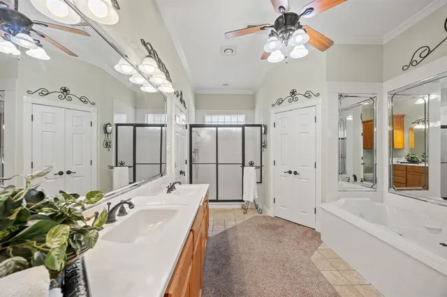 a spacious bathroom with a tub shower and mirror