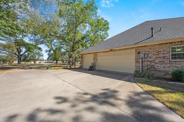 a view of a patio with table and chairs and potted plants