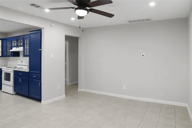 wooden floor in an empty room and a ceiling fan