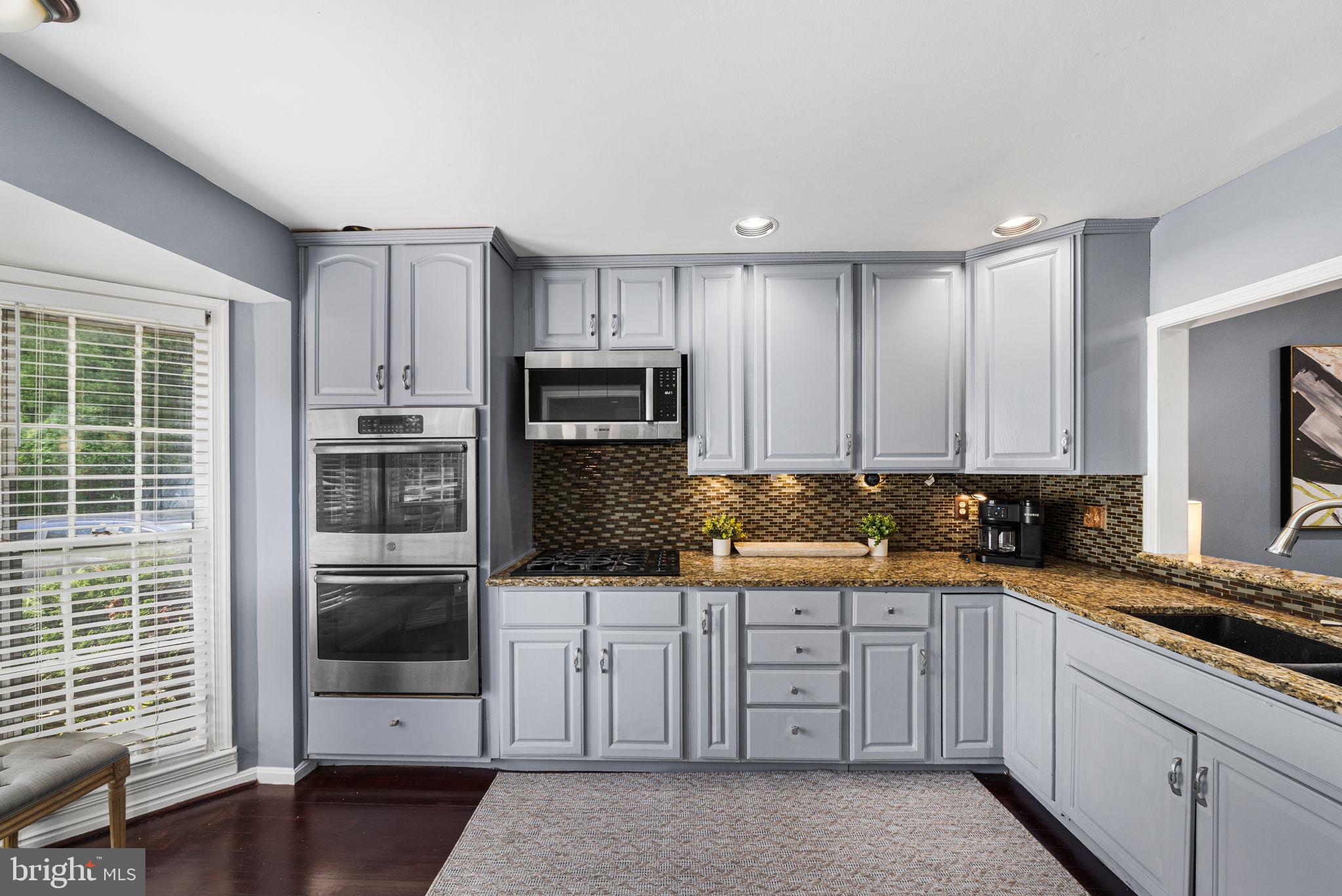 7403 Ridge Oak Court Springfield, VA 22153 - Photo 13 of 54 a kitchen with stainless steel appliances a stove sink microwave and refrigerator
