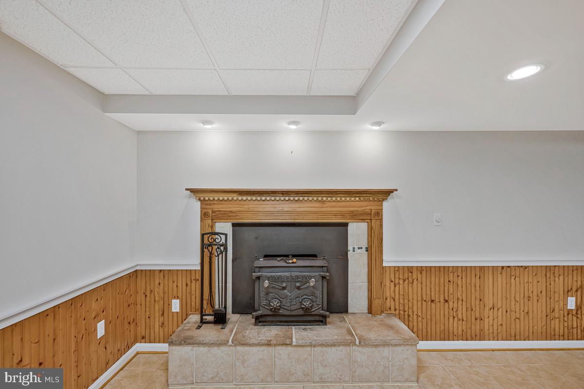 7185 Hawthorne Road La Plata, MD 20646 - Photo 53 of 59 Cozy fireplace in a stylish basement.