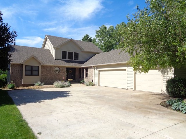 10215 East Hickory Ridge Drive Rochelle, IL 61068 - Photo 1 of 16 a front view of a house with a yard and garage
