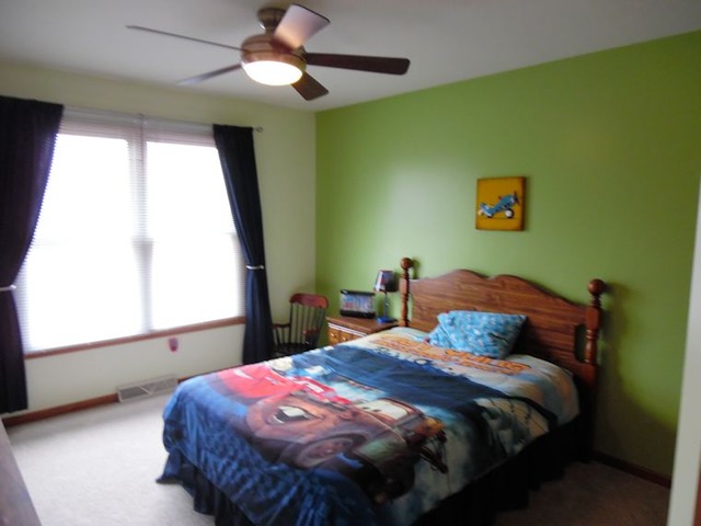 10215 East Hickory Ridge Drive Rochelle, IL 61068 - Photo 14 of 16 a bedroom with a bed and a window