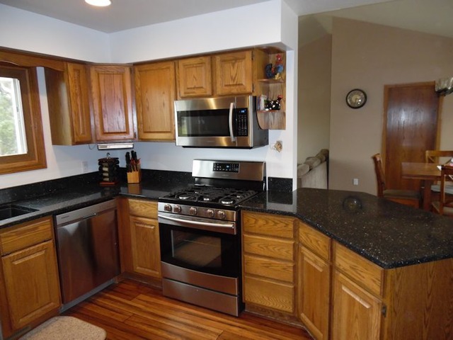 10215 East Hickory Ridge Drive Rochelle, IL 61068 - Photo 3 of 16 a kitchen with granite countertop a stove and a sink