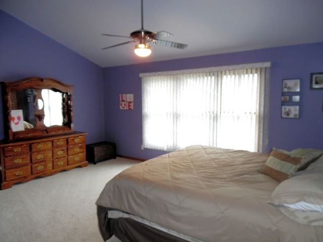 10215 East Hickory Ridge Drive Rochelle, IL 61068 - Photo 9 of 16 a bedroom with a bed and a dresser