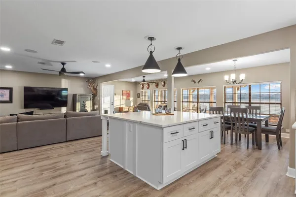 a kitchen with white cabinets appliances and sink