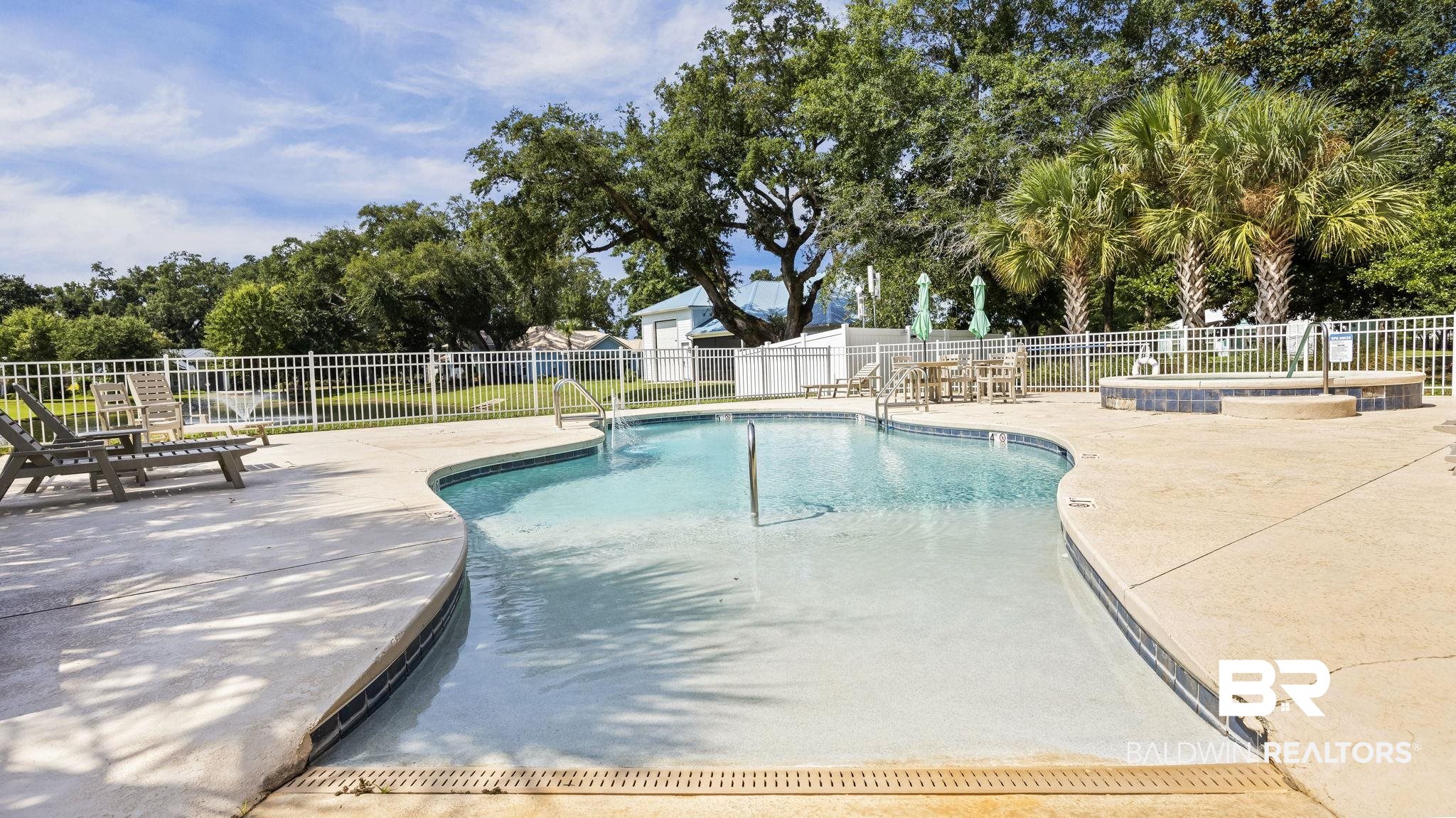 12361 Reunion Place Foley, AL 36535 - Photo 33 of 43 Community pool with a patio area and a fenced backyard