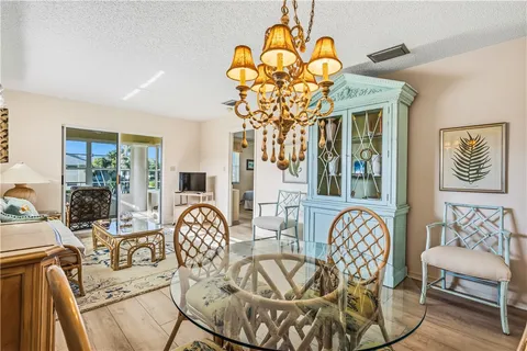 a view of a dining room with furniture wooden floor and chandelier