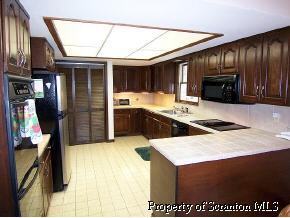 3138 Blue Spruce Road Moscow, PA 18444 - Photo 6 of 6 a kitchen with stainless steel appliances granite countertop a stove a sink and a refrigerator