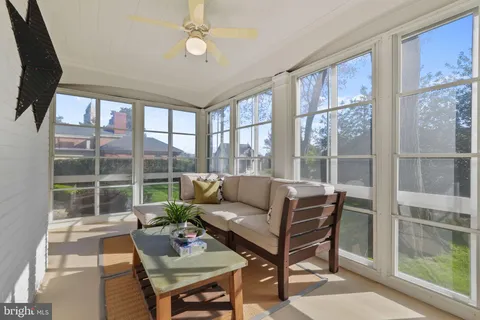 a bathroom with a granite countertop sink mirror and a toilet