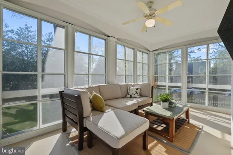 a view of a room with wooden floor and furniture