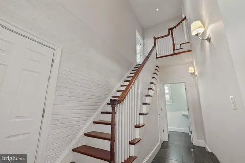 a kitchen with stainless steel appliances granite countertop a sink a stove and cabinets
