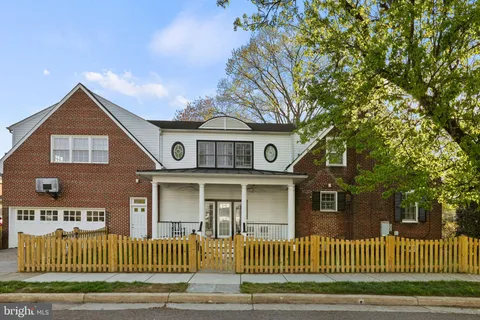 a kitchen with stainless steel appliances a stove a sink dishwasher a refrigerator and white cabinets with wooden floor