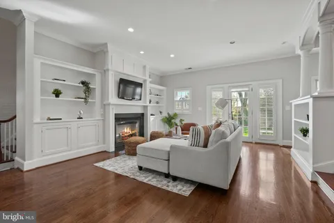 a living room with furniture a fireplace and a window