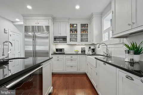 a spacious bedroom with a large bed and a dresser