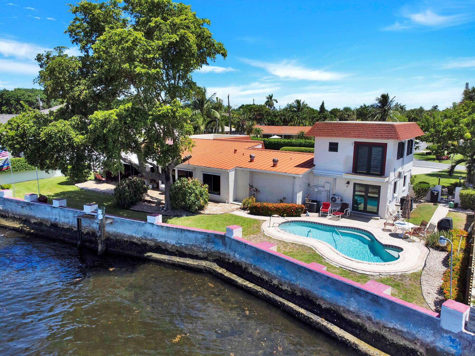 a swimming pool with outdoor seating and yard